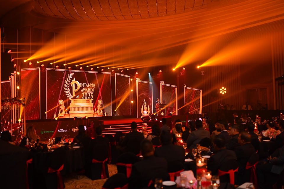 Awards ceremony stage with warm lighting beams
