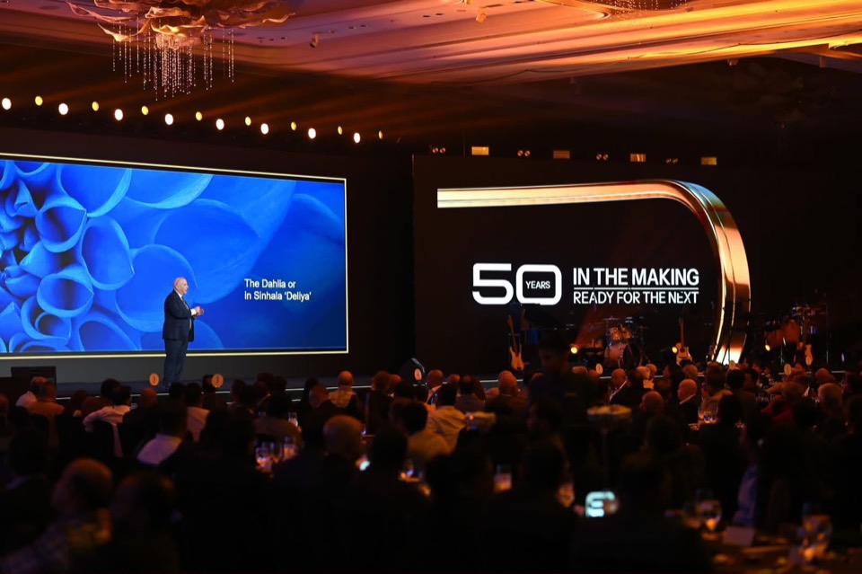 Gala dinner with a presenter on stage beside LED screens
